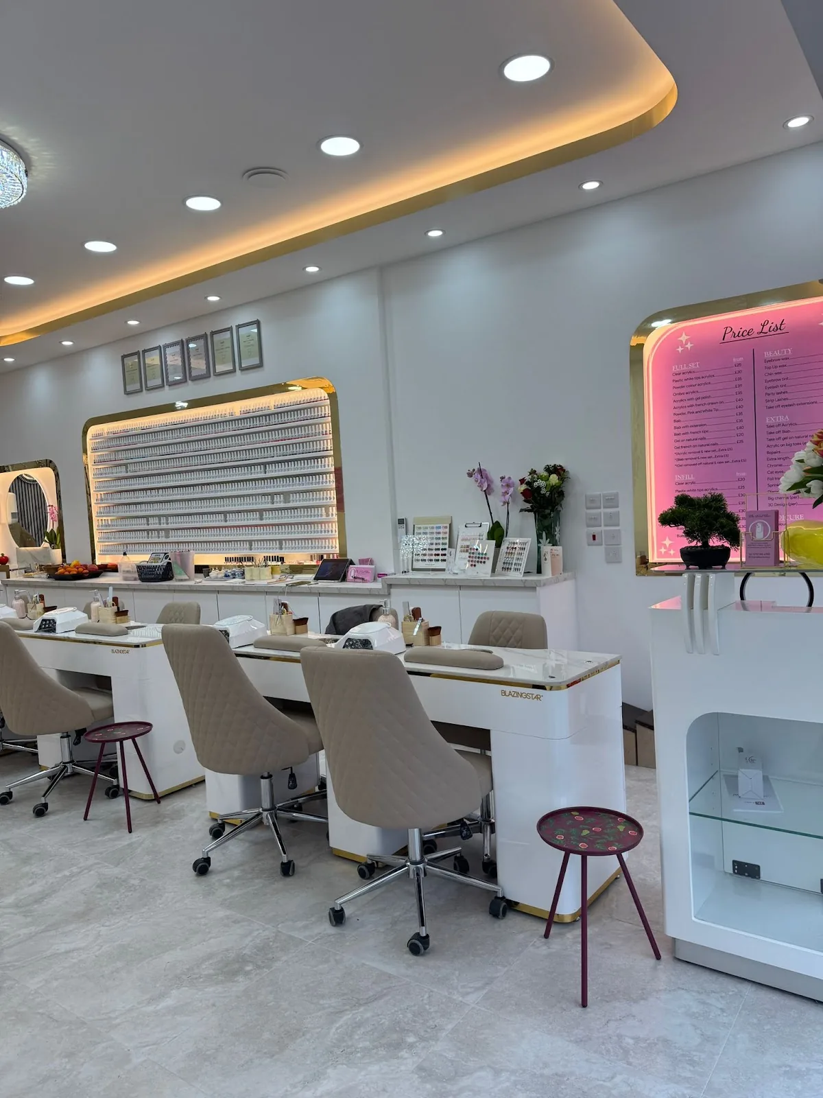Inside The Nail Bar in Farnworth — manicure stations, a full wall of polish, and the pink price board